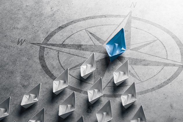 a lead paper boat leading a formation of smaller boats