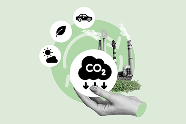 Various green energy symbols with factory stack in background